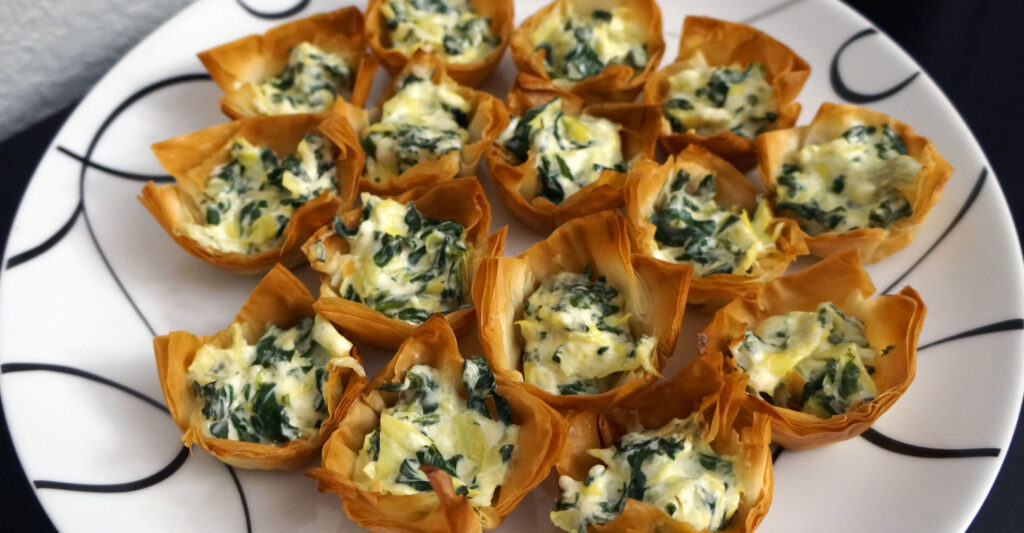Baked spinach and artichoke dip served in crisp phyllo shells as an easy finger food appetizer.