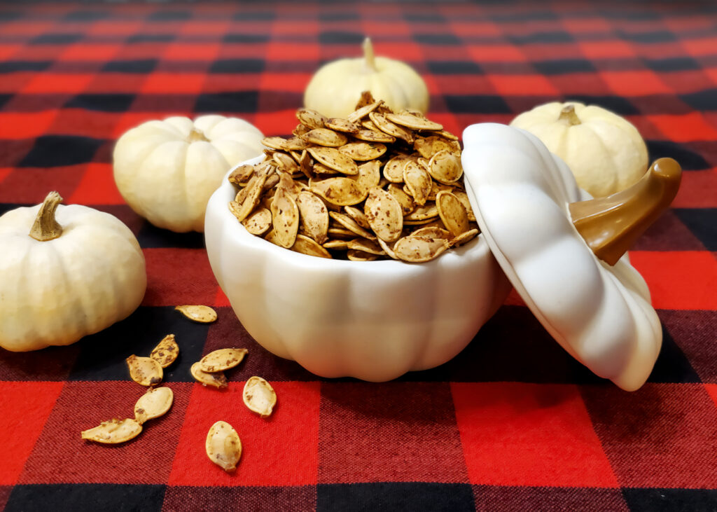 Golden roasted pumpkin seeds seasoned with butter and Worcestershire sauce, ready to snack on.