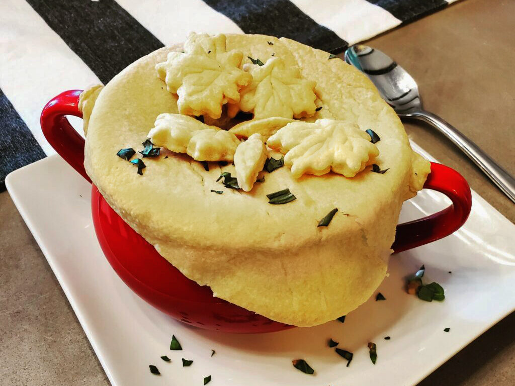 Individual turkey pot pies baked in ramekins with golden pie crust tops.