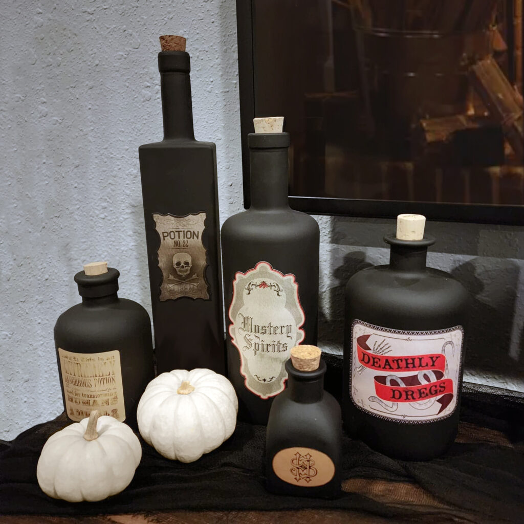 DIY potion bottles displayed on a fireplace mantle, mixed with different bottle shapes for a spooky, eclectic look.