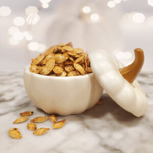 Golden roasted pumpkin seeds seasoned with butter and Worcestershire sauce, ready to snack on.