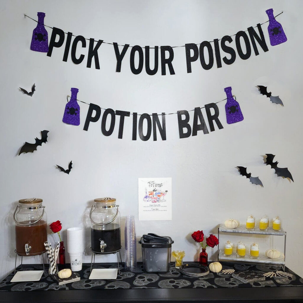 Black Magic Halloween potion bar with themed cocktails, skull glassware, and custom drink menu.