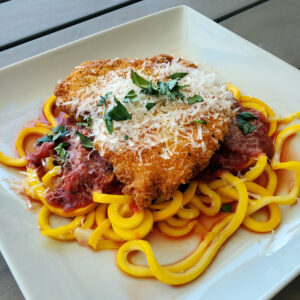 Crispy chicken parmesan served on zucchini noodles with marinara sauce.
