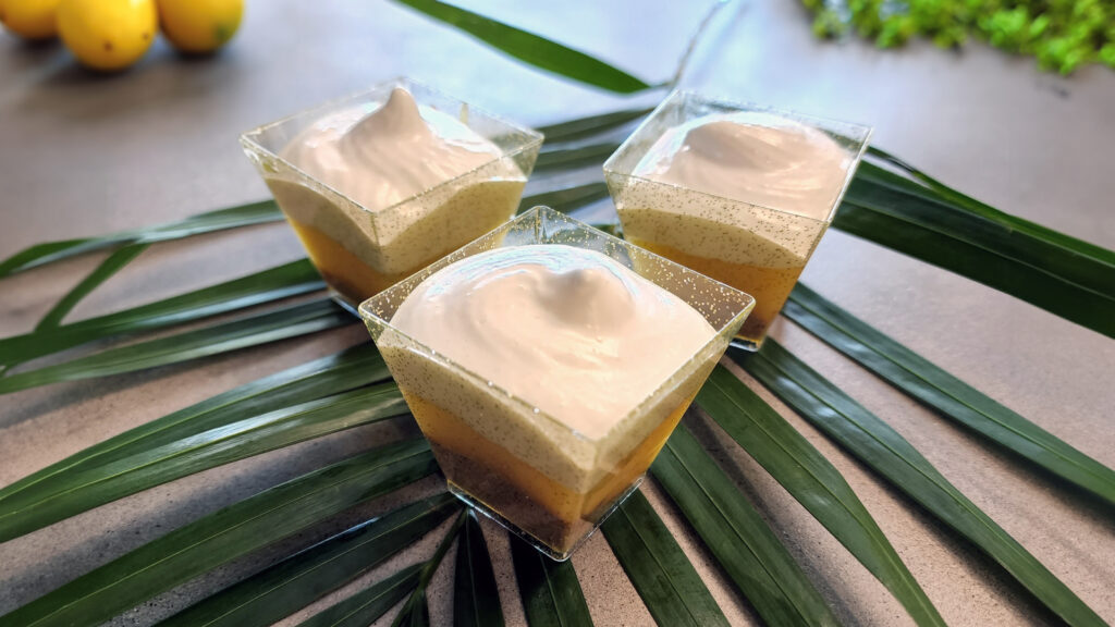 Lemon meringue pie shooters arranged on a party dessert table, ready to serve.