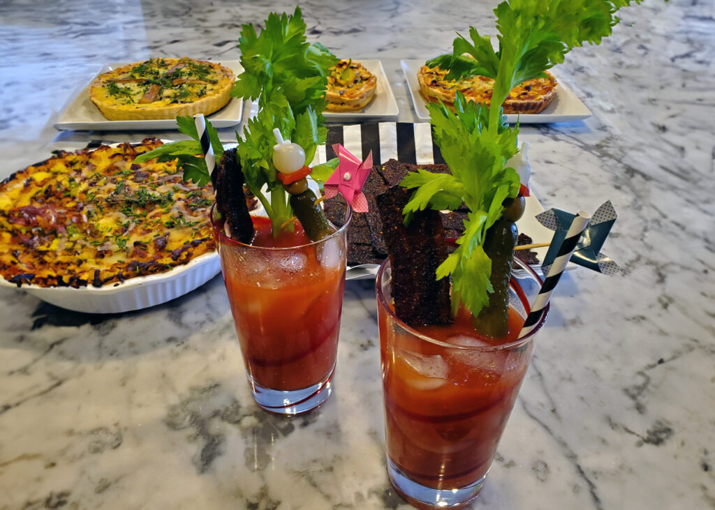 Bourbon Bloody Mary served over ice with BBQ-spiced rim and classic brunch garnishes.
