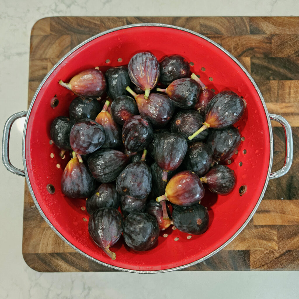 Whole and quartered ripe figs ready to be turned into jam.