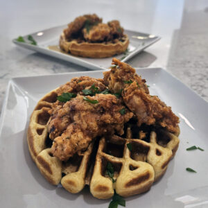 Plated chicken and waffles served hot and ready for brunch.