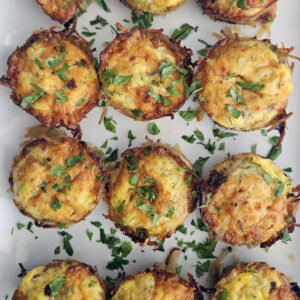 Egg bites arranged on a serving plate with optional garnishes for brunch.