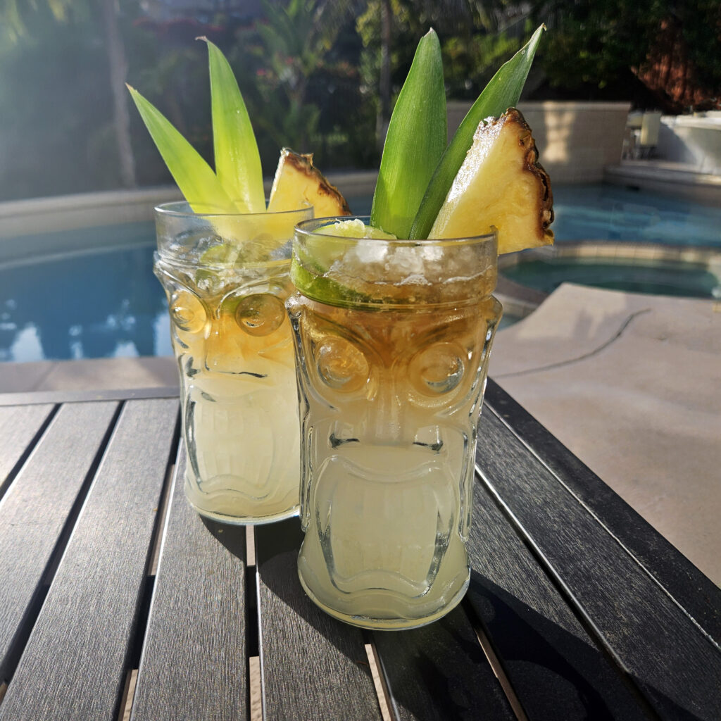 Mai Tai served in a decorative tiki glass with crushed ice and citrus garnish.