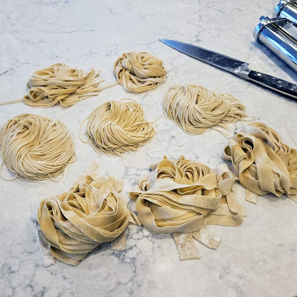 Freshly cut pasta noodles laid out before cooking.