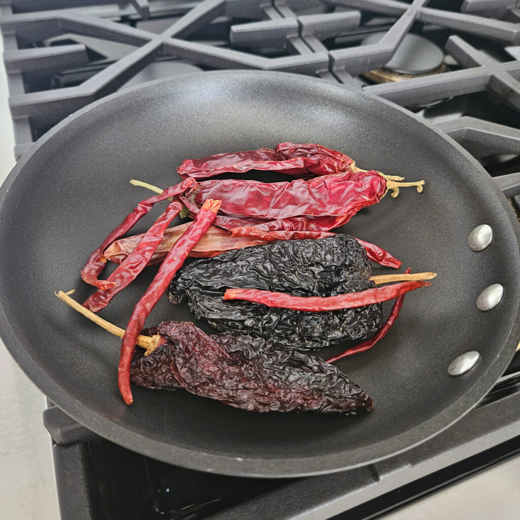 Ancho, guajillo, and chile de árbol peppers prepared for making mole rojo sauce.