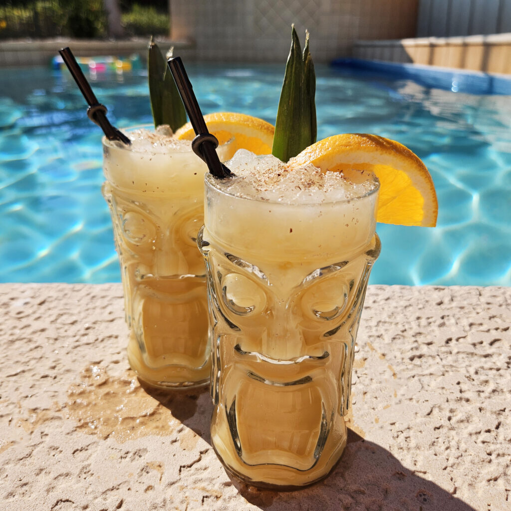 Painkiller cocktail styled for a tropical setting with citrus and pineapple accents.