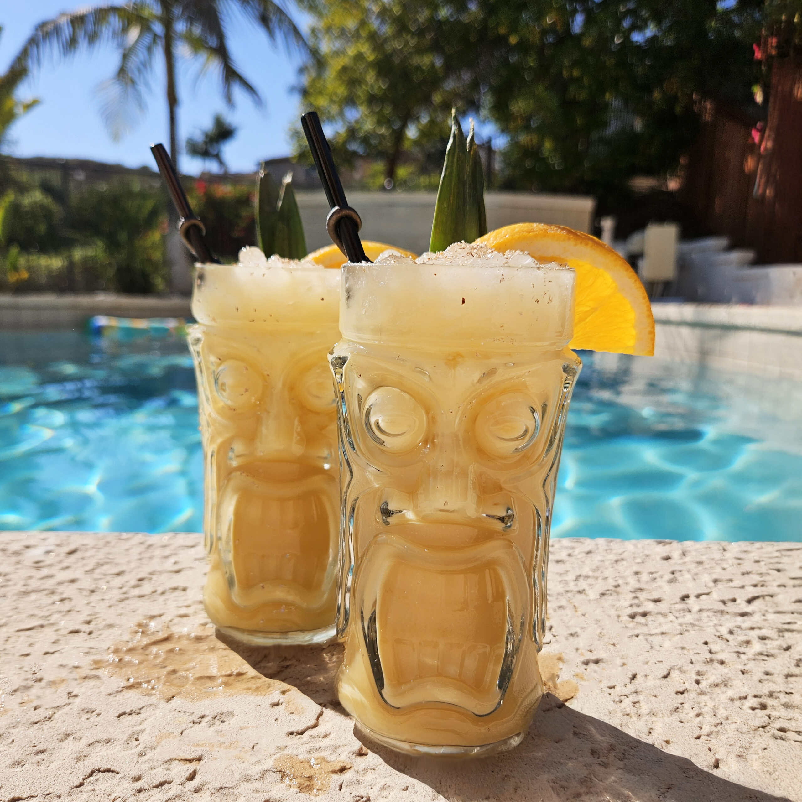 Painkiller cocktail styled for a tropical setting with citrus and pineapple accents.