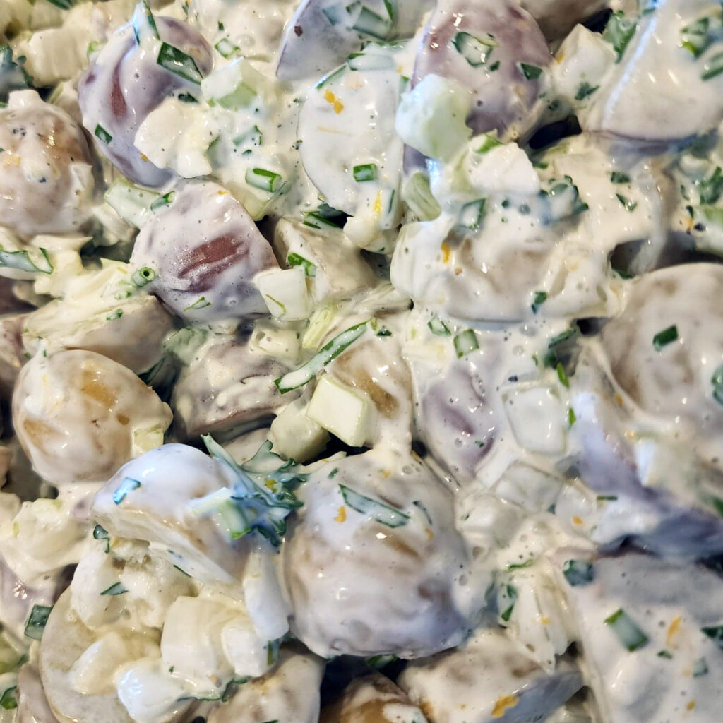 Detailed view showing tender potatoes coated in creamy lemon dressing.