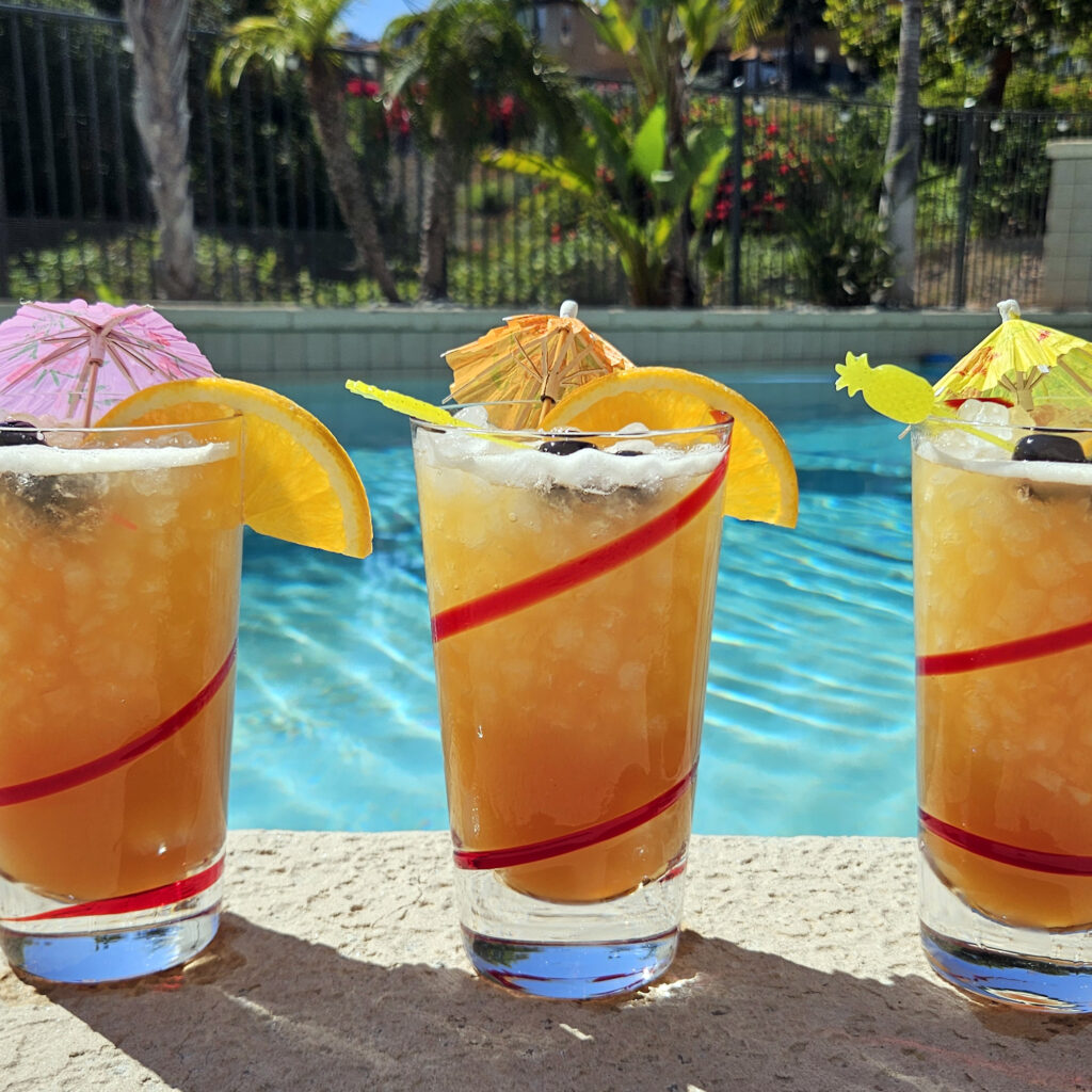Rum punch cocktail served over nugget ice in a clear glass.