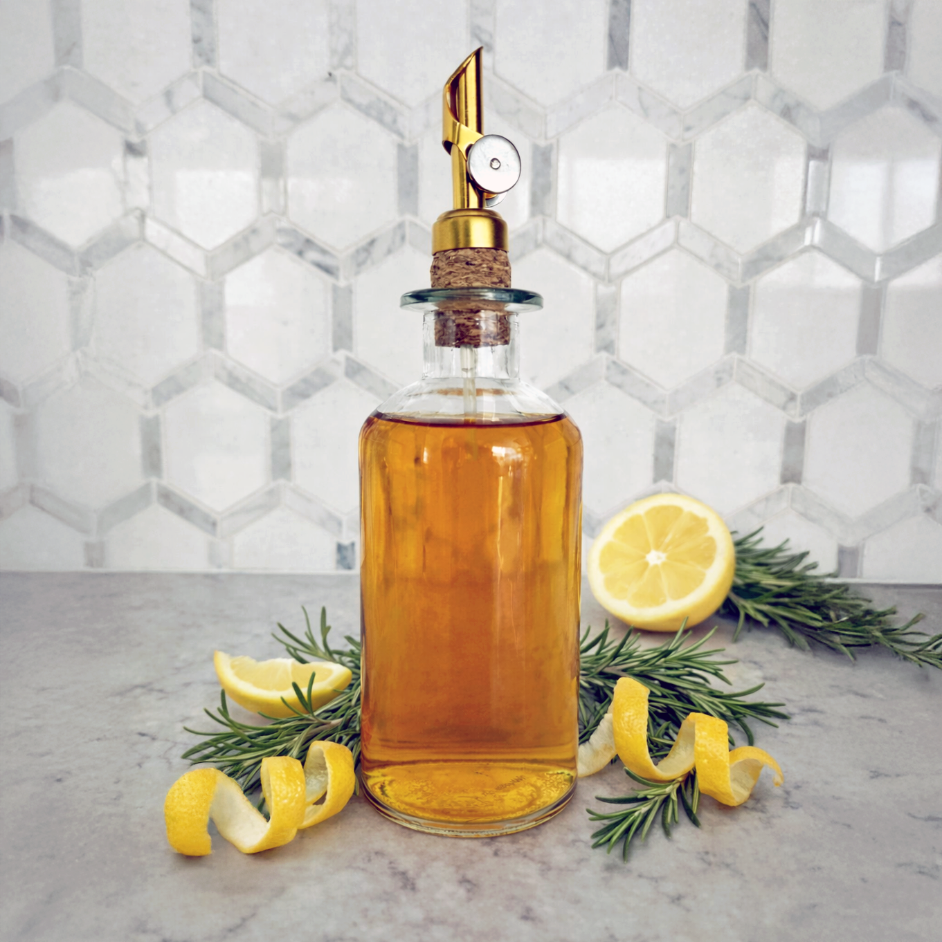 Fresh lemon peels and rosemary sprigs next to a bottle of lemon rosemary simple syrup.