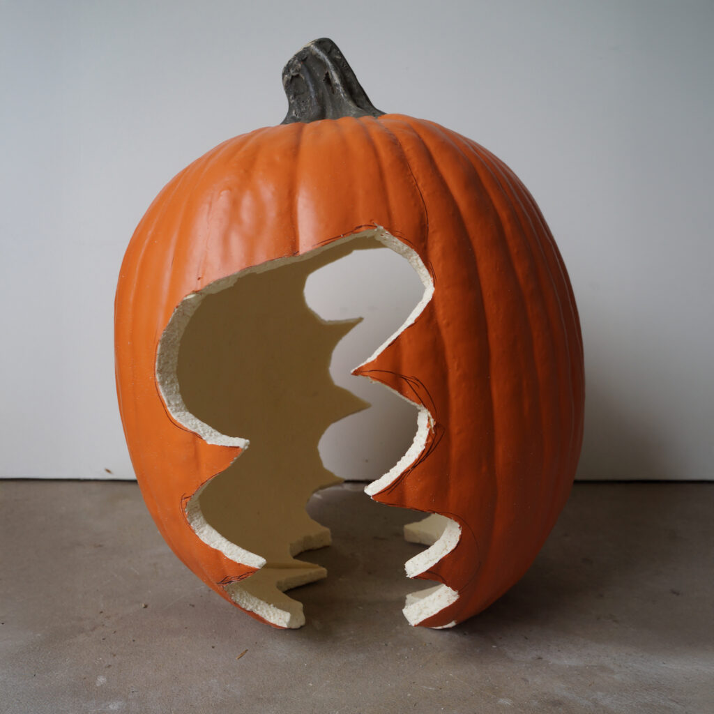 Craft foam pumpkin with a jagged, open mouth cut out, creating the base shape for a giant Venus fly trap.