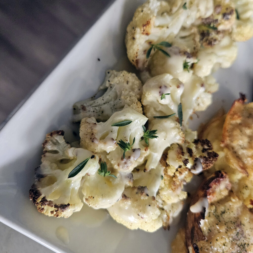 Roasted cauliflower drizzled with warm beer cheese sauce, finished with black pepper.