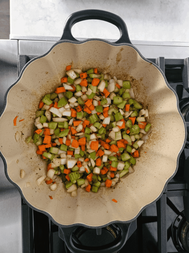 Step-by-step cooking process of short rib ragù, showing soffritto, tomato paste development, and simmered sauce in a Dutch oven.